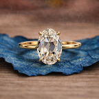 Gold ring with a large diamond on a blue stone surface