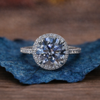 Diamond ring on a blue leaf with a blurred brown 