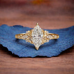 Gold ring with a large diamond on a blue leaf