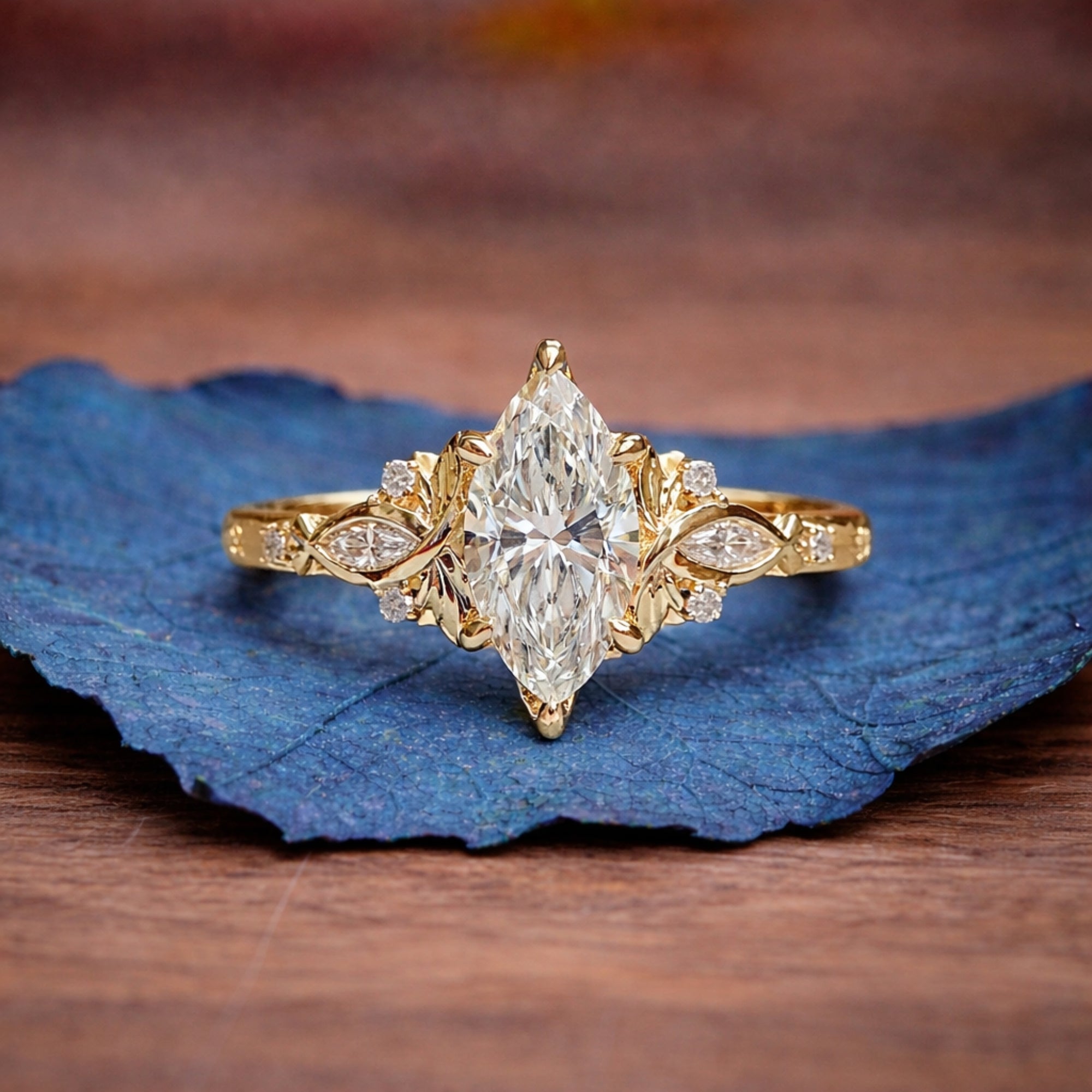 Gold ring with a large diamond on a blue leaf