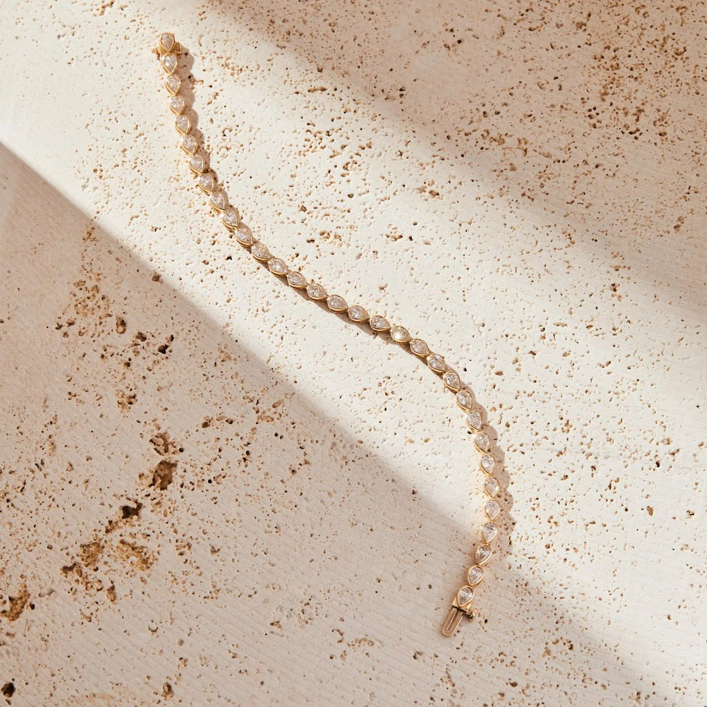 Pearl necklace on a textured beige surface