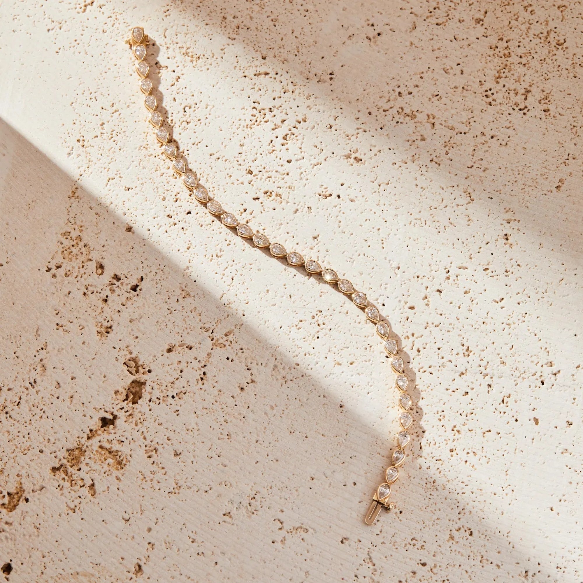 Pearl necklace on a textured beige surface