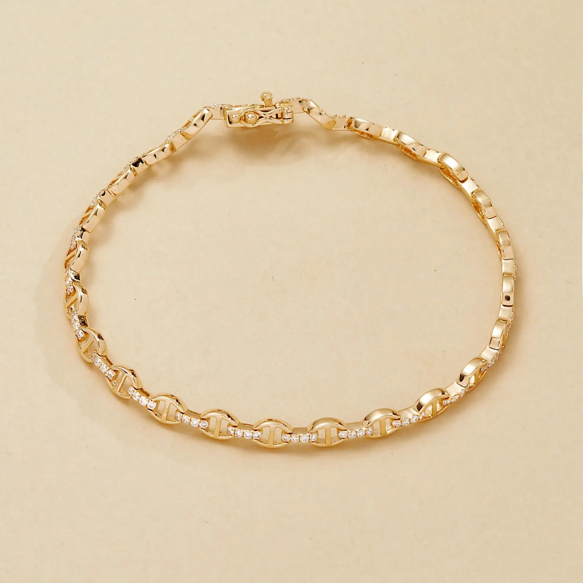 Gold bracelet on a beige 