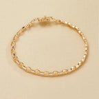 Gold bracelet on a beige 