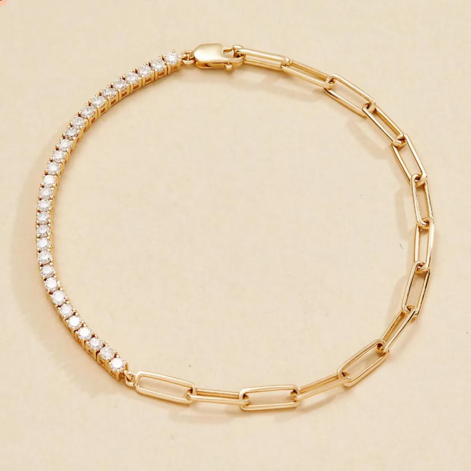 Gold bracelet with clear stones on a beige 