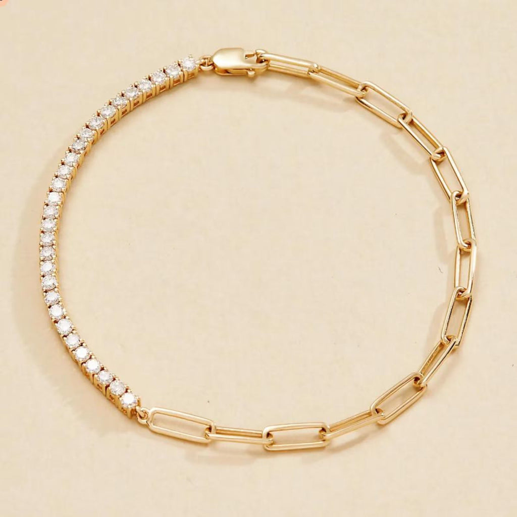 Gold bracelet with clear stones on a beige 