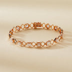 Rose gold bracelet with diamond accents on a beige 