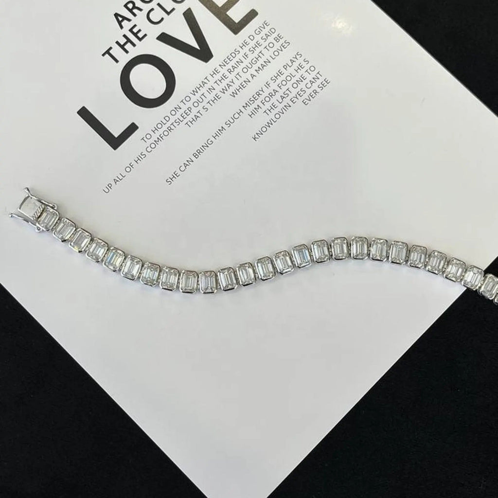 Silver bracelet on a card with text