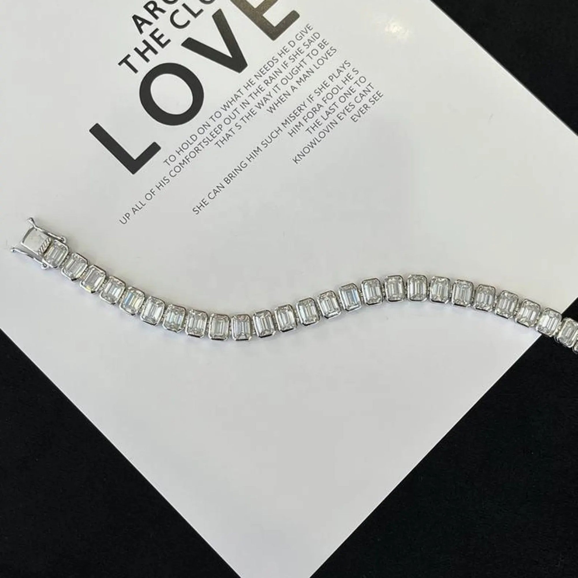 Silver bracelet on a card with text
