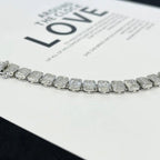 Silver bracelet with rectangular gemstones on a magazine page