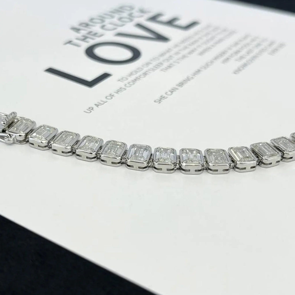 Silver bracelet with rectangular gemstones on a magazine page