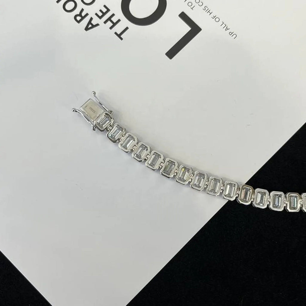 Silver bracelet on a black and white checkered 