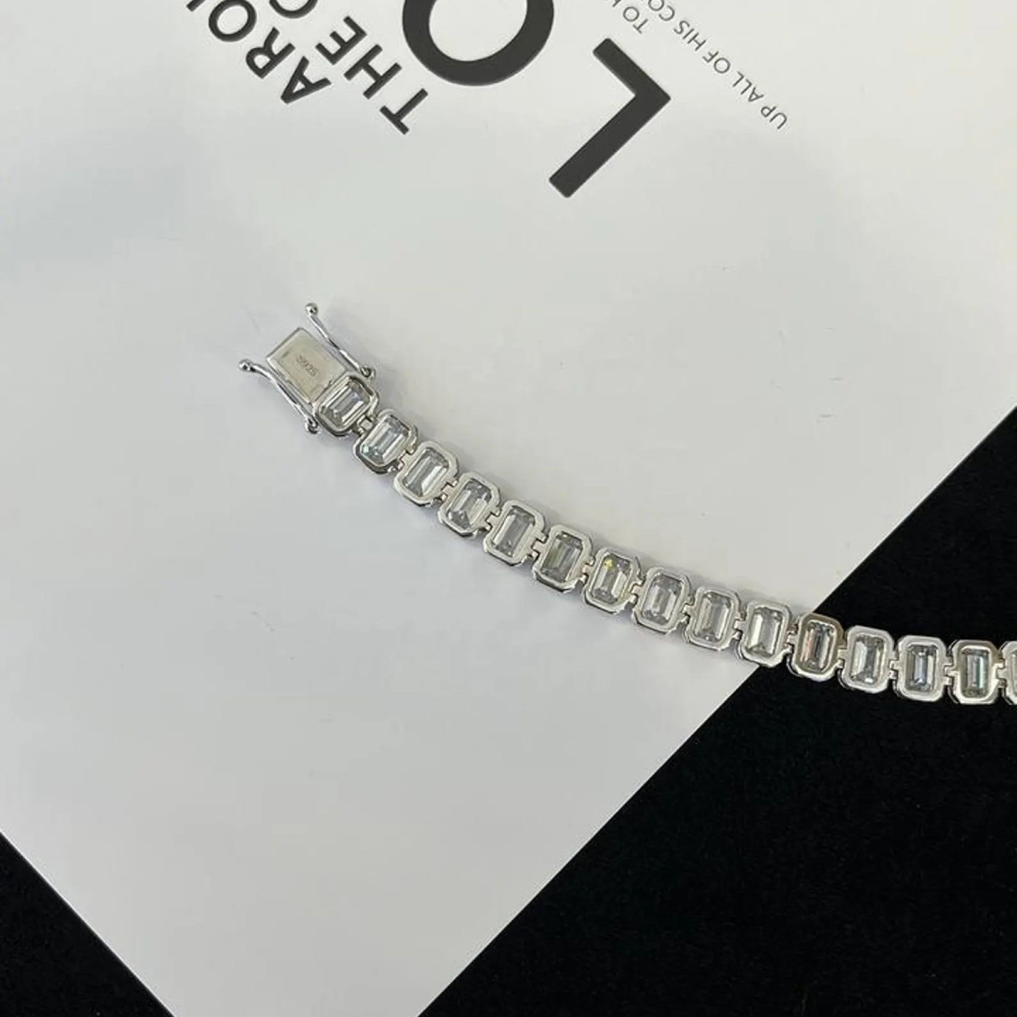 Silver bracelet on a black and white checkered 